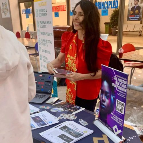 A woman wearing a red top and a scarf with yellow patterns